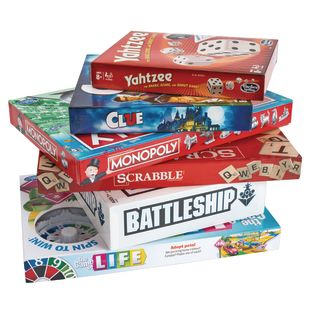 A stack of board game against a white backdrop. 